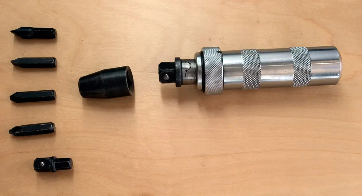 A manual impact driver (for use with hammer) with screwdriver bits and adapters